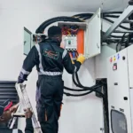 Electrical power project. Technician installing main power breaker 400A panel in a client site.