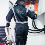 Electrical power project. Technician installing main power breaker 400A panel in a client site.