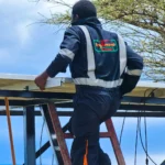 Project for solarization of borehole in Amboseli. A technician installing solar panels for a borehole.