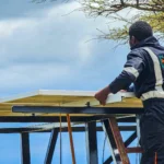 Project for solarization of borehole in Amboseli. A technician installing solar panels for a borehole.
