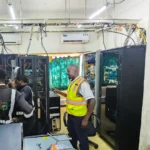 Power stabilisation project. Technicians installing Victron Power backup and new power cables in a server room
