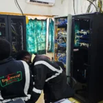 Power stabilisation project. Technicians installing Victron Power backup and new power cables in a server room