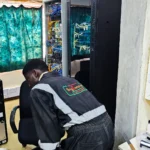 Power stabilisation project. Technicians installing Victron Power backup and new power cables in a server room