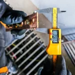 Power upgrade project. A technician taking measurements of busbars.