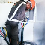 Power upgrade project. A technician terminating lugs on a new electrical installation.