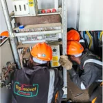 Power project. Technicians installing an electrical bypass panel for the new AVR supplied.