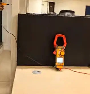 A power clamp metre testing earthing and equipotential bonding of a completed electrical installation.