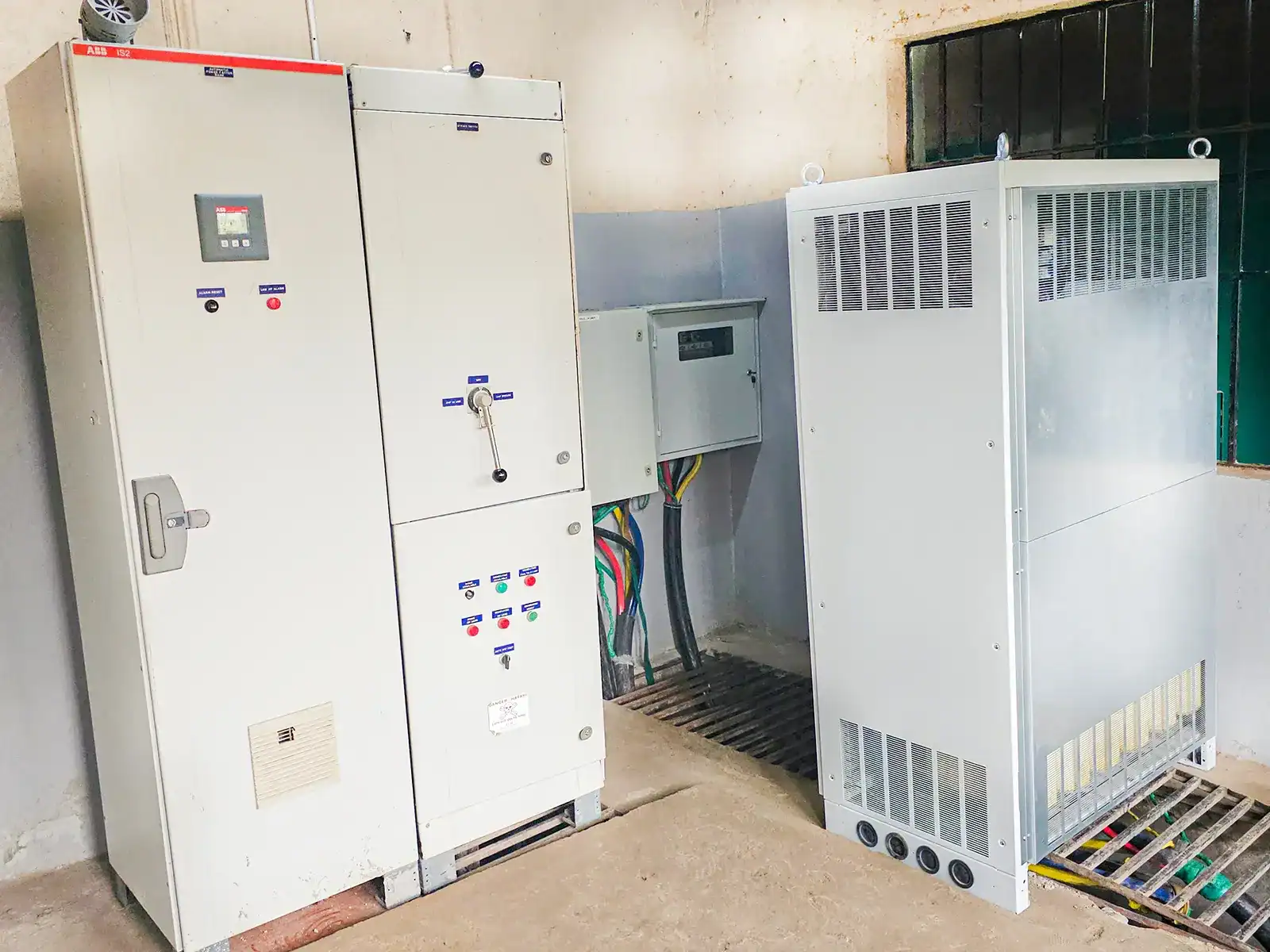 Completed installation of AVR and power factor correction system in a main power room.