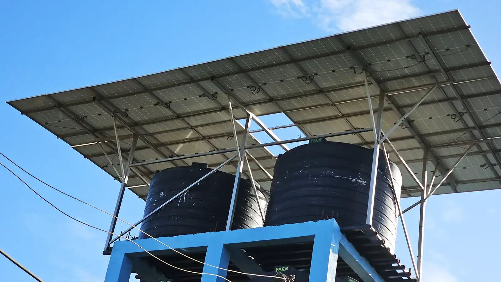 Completed 15kW installation for solar-powered water pumping system supplying elevated storage tanks using rooftop solar panels.