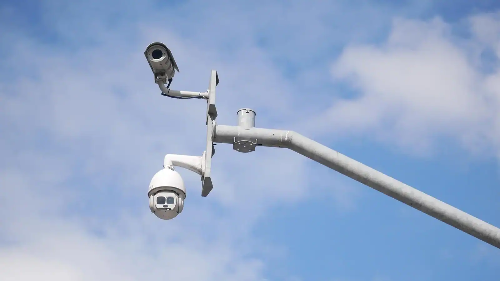 Outdoor PTZ and fixed CCTV cameras mounted on a pole for wide-area surveillance and security monitoring.
