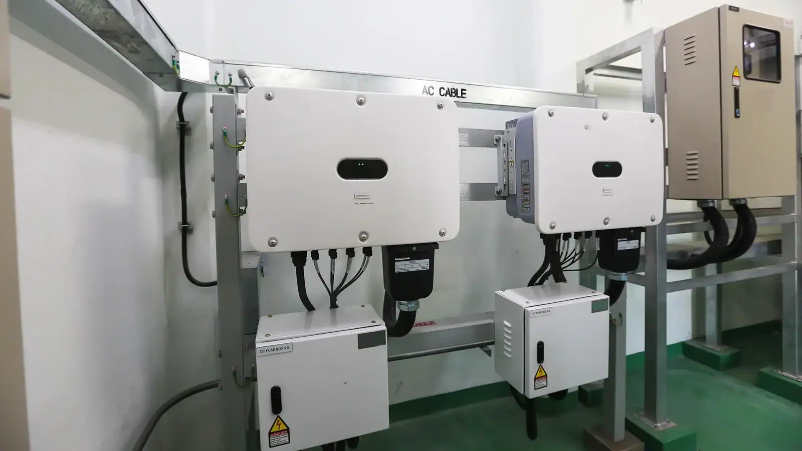 Grid-tied solar inverter system installed in electrical room with AC and DC distribution units.