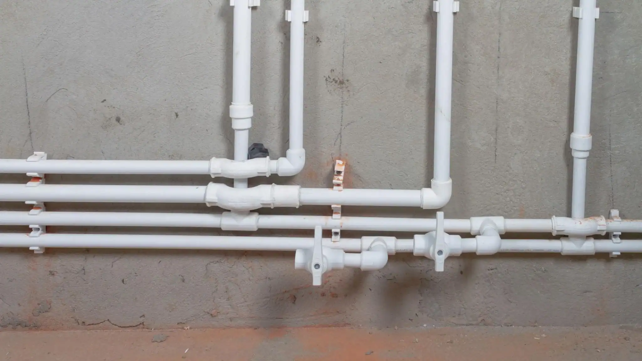 Hot water distribution and control PVC piping system with valves in a domestic installation.