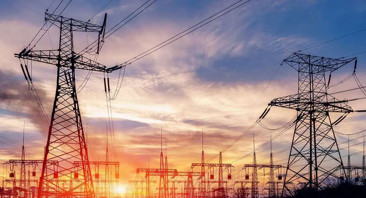 High voltage transmission lines and electrical substations used for power distribution and grid control.