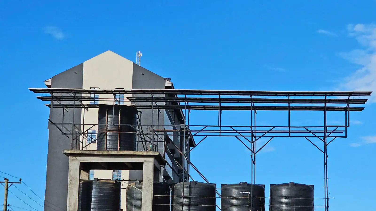 Elevated water storage tanks and solar-powered distribution system for water supply