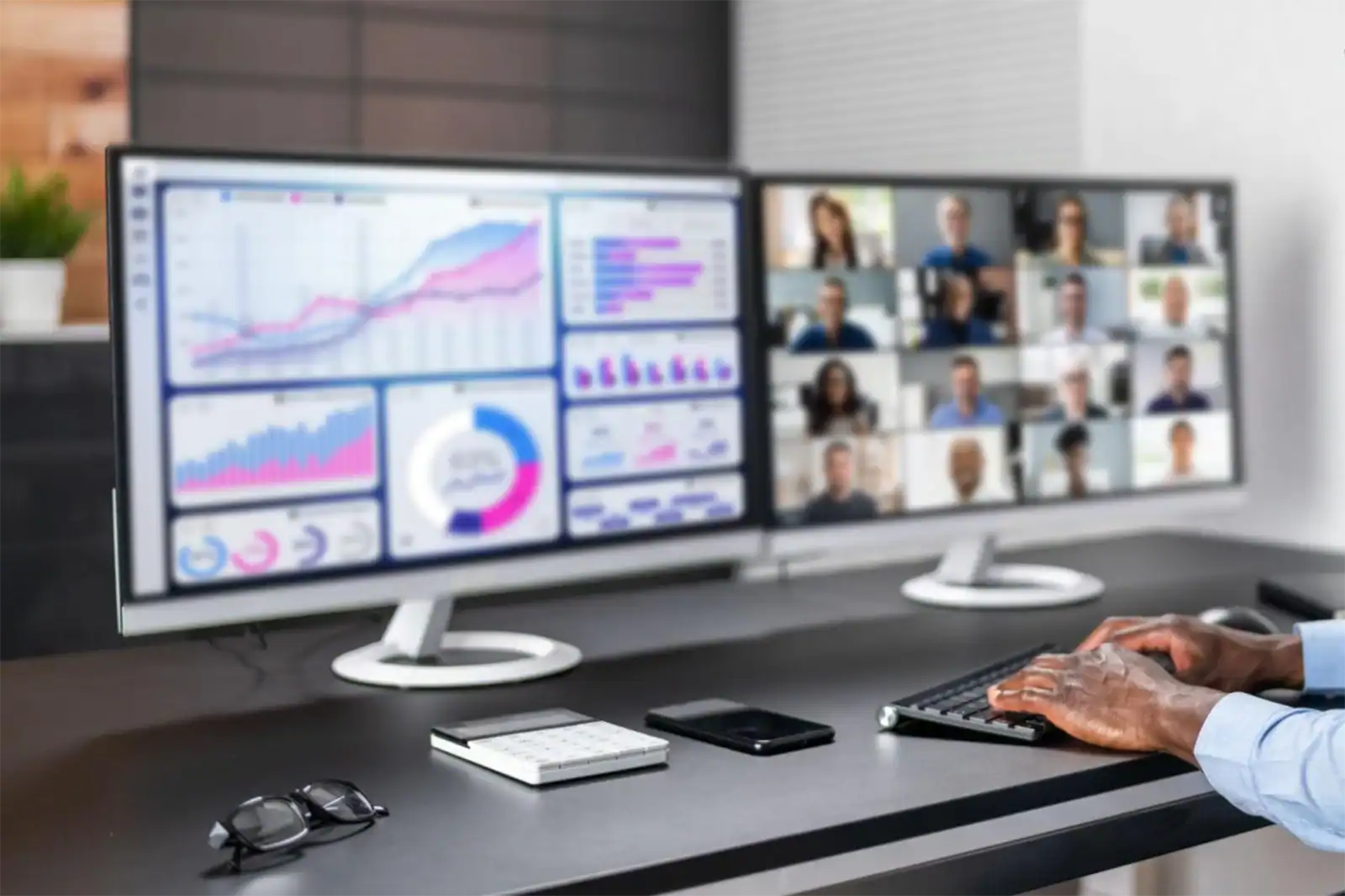 Unified communication setup with dual monitors showing analytics dashboard and video conferencing for enterprise collaboration.