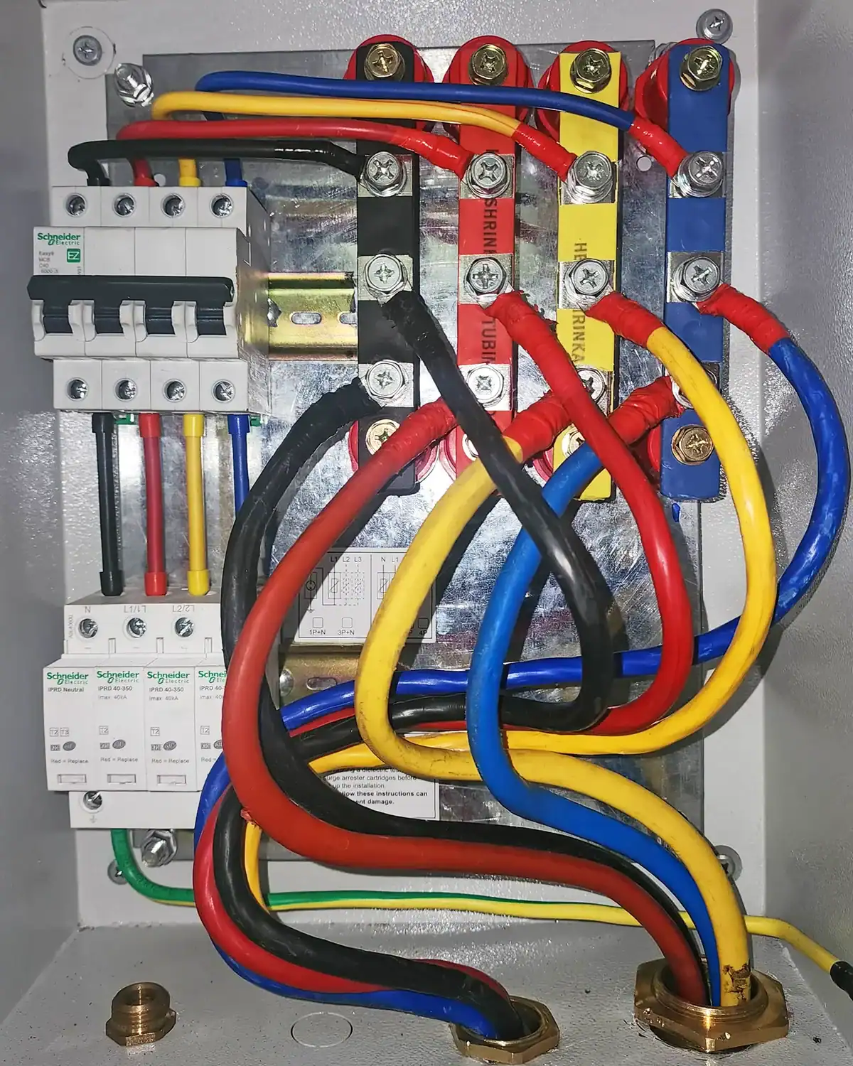 40kA surge protection device installed in a three-phase main power distribution panel for electrical system protection in a bank branch.