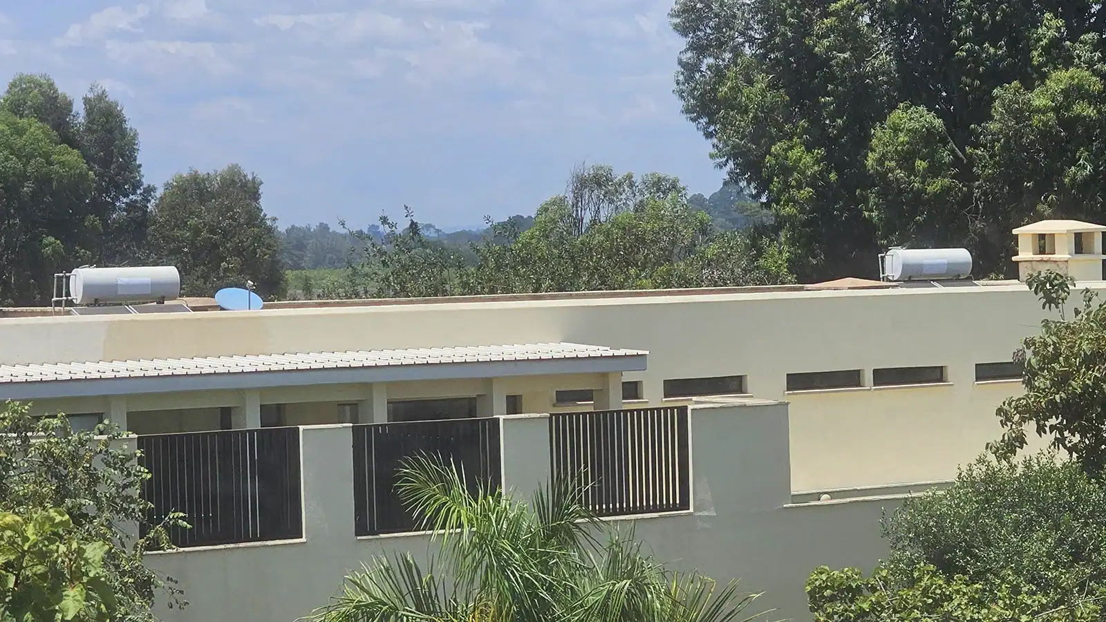 Solar water heater with insulated storage tank and evacuated tube collectors in an institution.