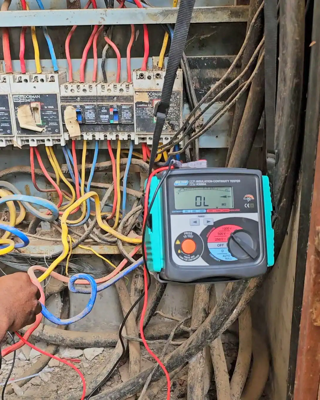 Majortech insulation resistance tester displaying an OL reading, verifying zero electrical leakage in the buried sub-main cables.
