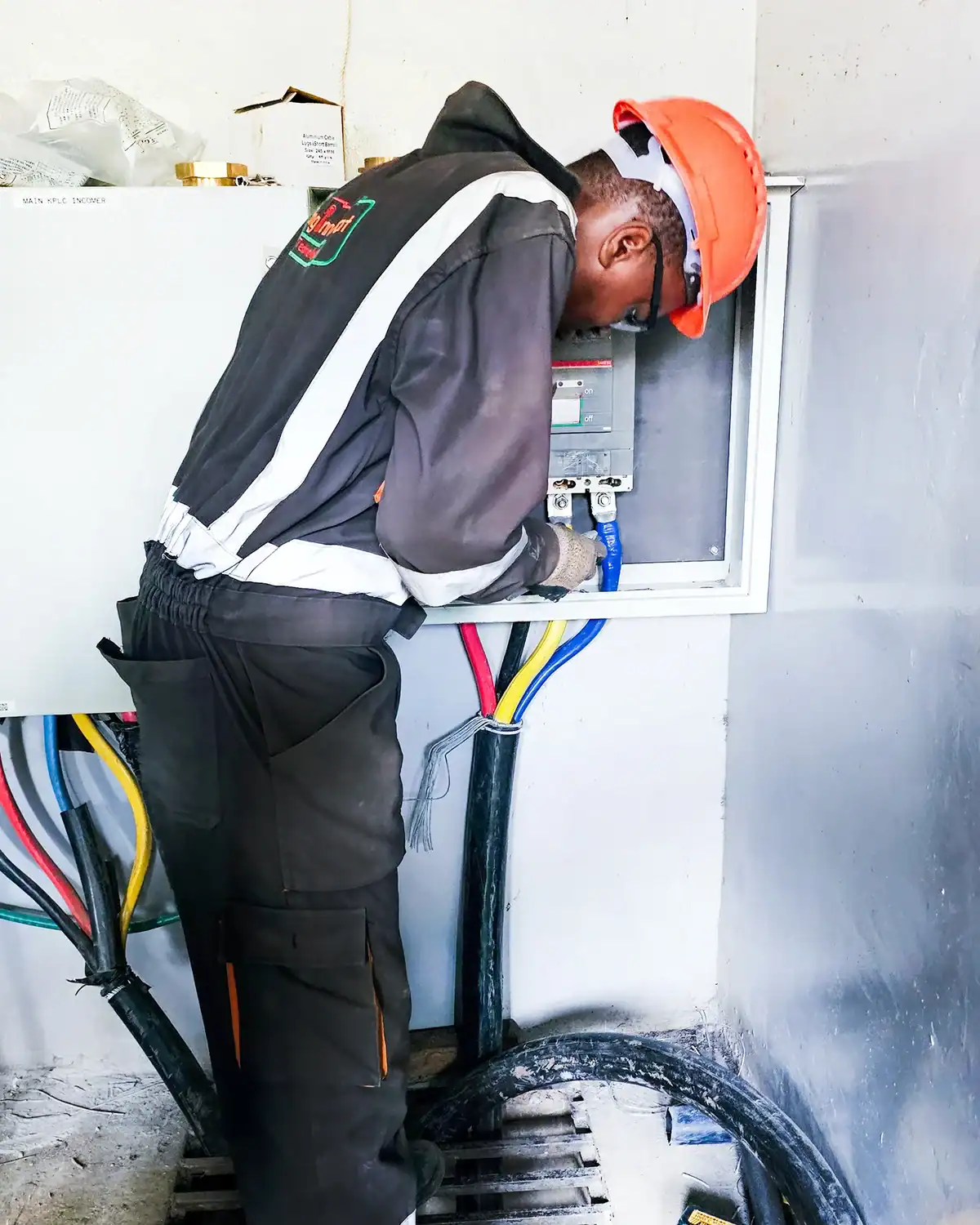 Enginnovat technician installing heavy-duty lugs and terminating main power cables onto a new motorized breaker.
