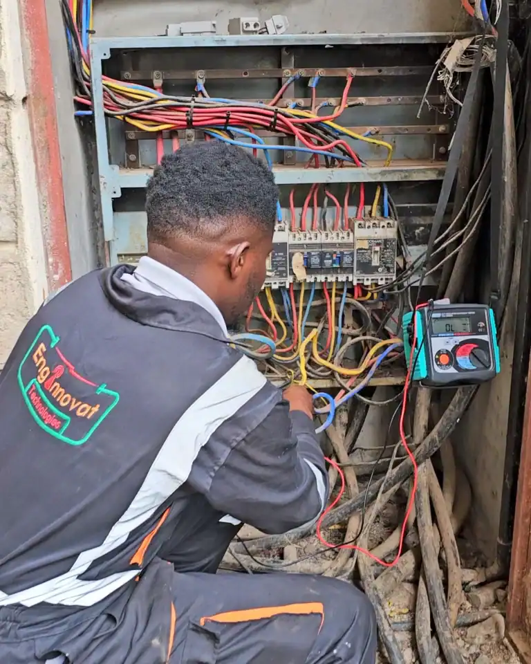 Enginnovat technician conducting insulation resistance and continuity tests on a main distribution board.
